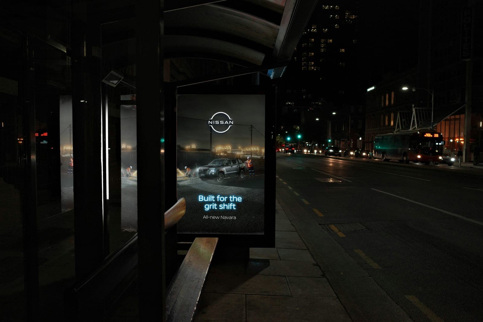 Built for the grit shift poster glowing in a bus shelter on an empty city street at night