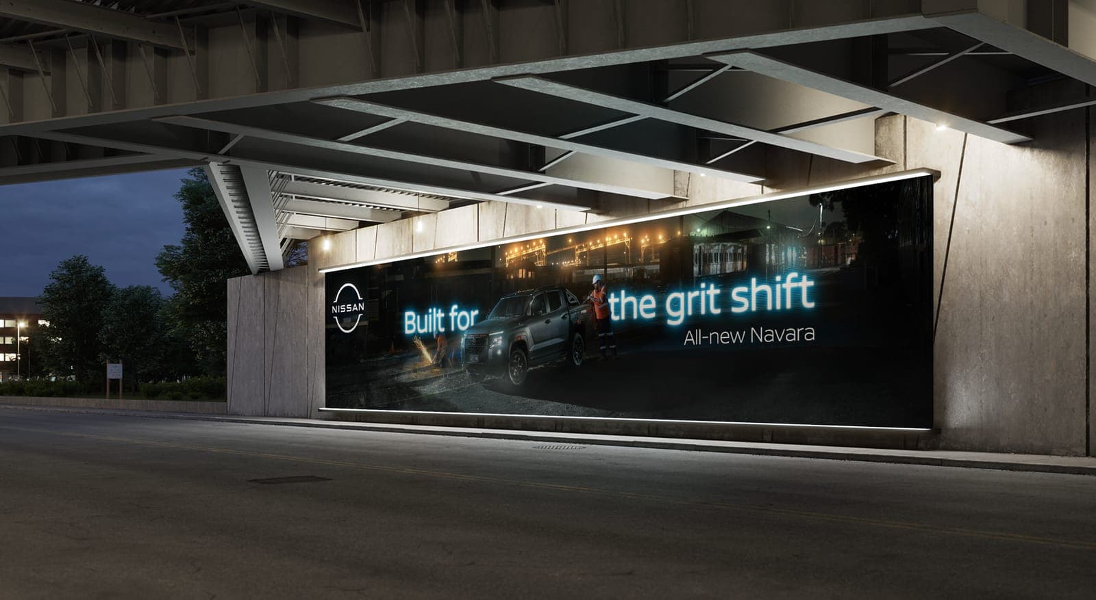 Built for the grit shift billboard lit up under a road overpass at night